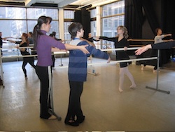 Yuka Kawazu corrects a young dancer in her ballet class