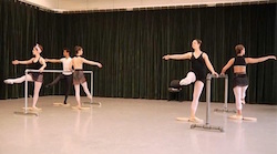 Towson University dance majors use rotator discs at the ballet barre to enhance turnout. Photo by David Merino.