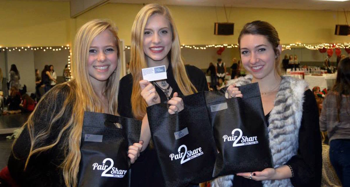 Juliana (left) Meriah (middle) Mekayla (right) at Pair2Share holiday event where Footnotes Dance Studio students bagged and added notes to shoes. Photo courtesy of Pair2Share.