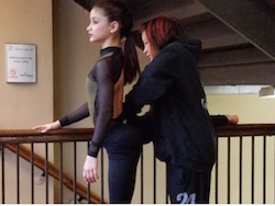 Dale Lam getting student Camille ready for her solo. Photo courtesy of Lam