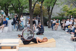 Alice Sheppard dancing in the park. Photo by Gim Ik Hyun.