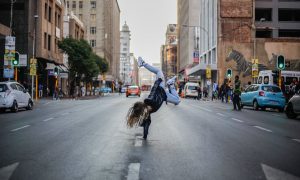 woman breakdancing on street