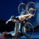 Laurel Lawson as Venus is flying in the air with arms spread wide, wheels spinning, and supported by Alice Sheppard as Andromeda who is lifting from the ground below. They are making eye contact and smiling. Photo by Jay Newman / BRITT Festival.