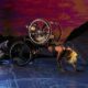 Two dancers, both in wheelchairs; one crawls forward and the other arches her back as she is dragged along the floor. A sunset appears behind them. Alice Sheppard and Laurel Lawson of Kinetic Light. Photo by MANCC/Chris Cameron.