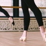 Dancers on a hardwood dance floor.