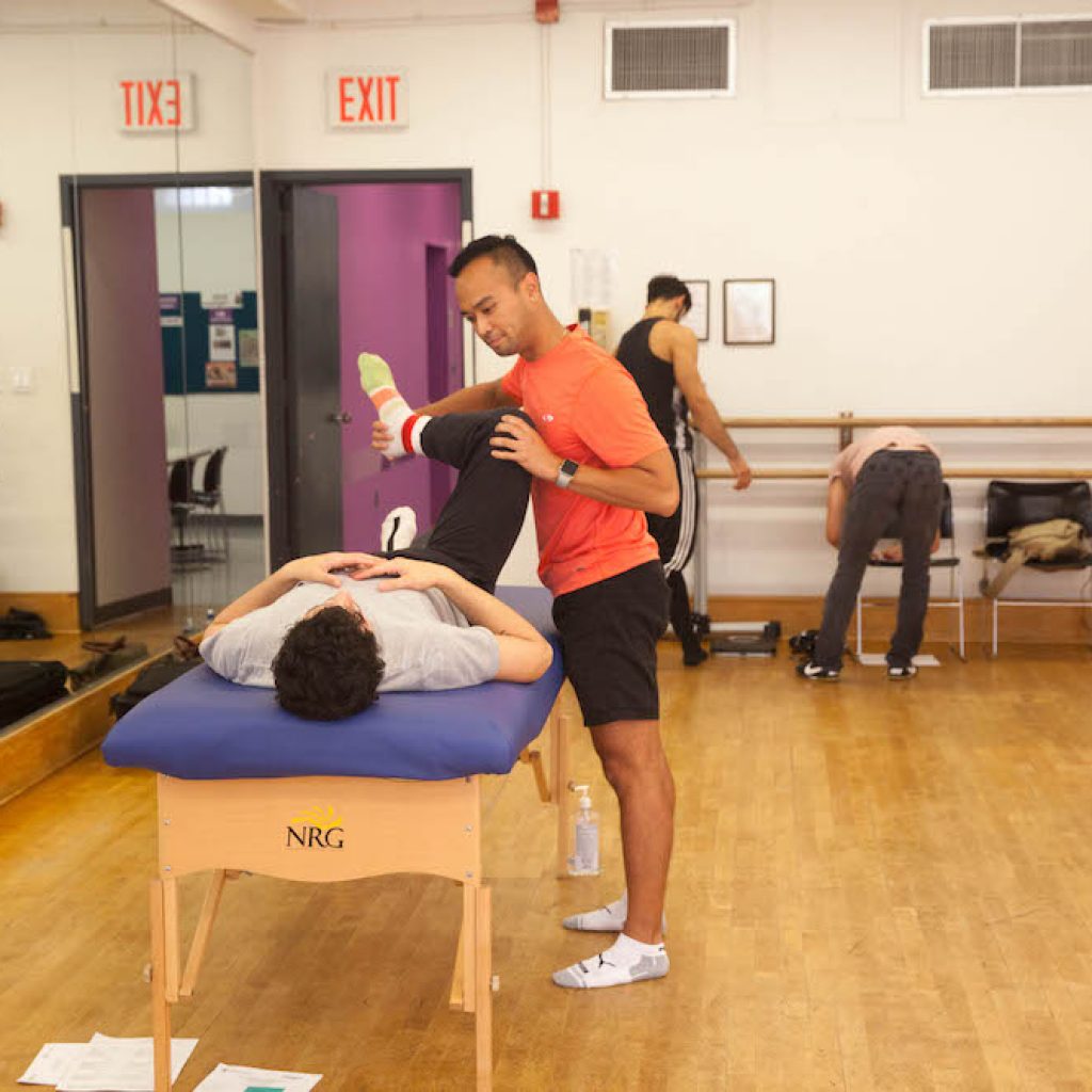 Joshua Honrado at screening table. Photo courtesy of Harkness Center for Dance Injuries.