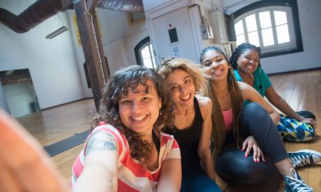 young women taking a group selfie at a dance studio