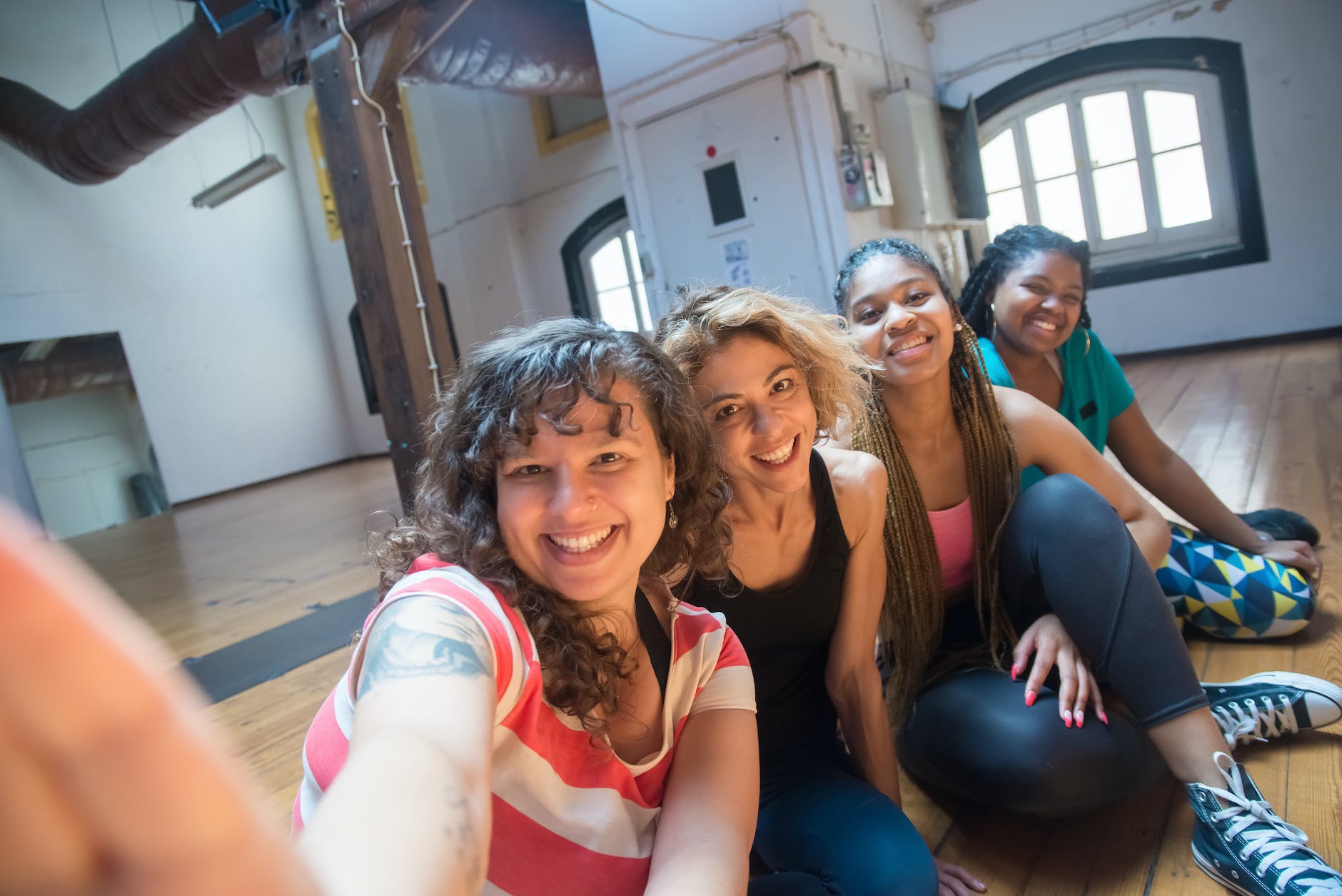 young women taking a group selfie at a dance studio