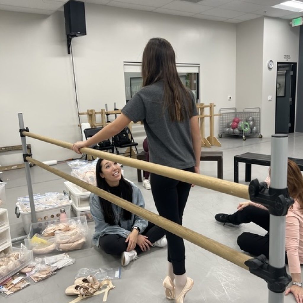 Josephine Lee fitting a dancer in pointe shoes. Photo courtesy of Lee. 
