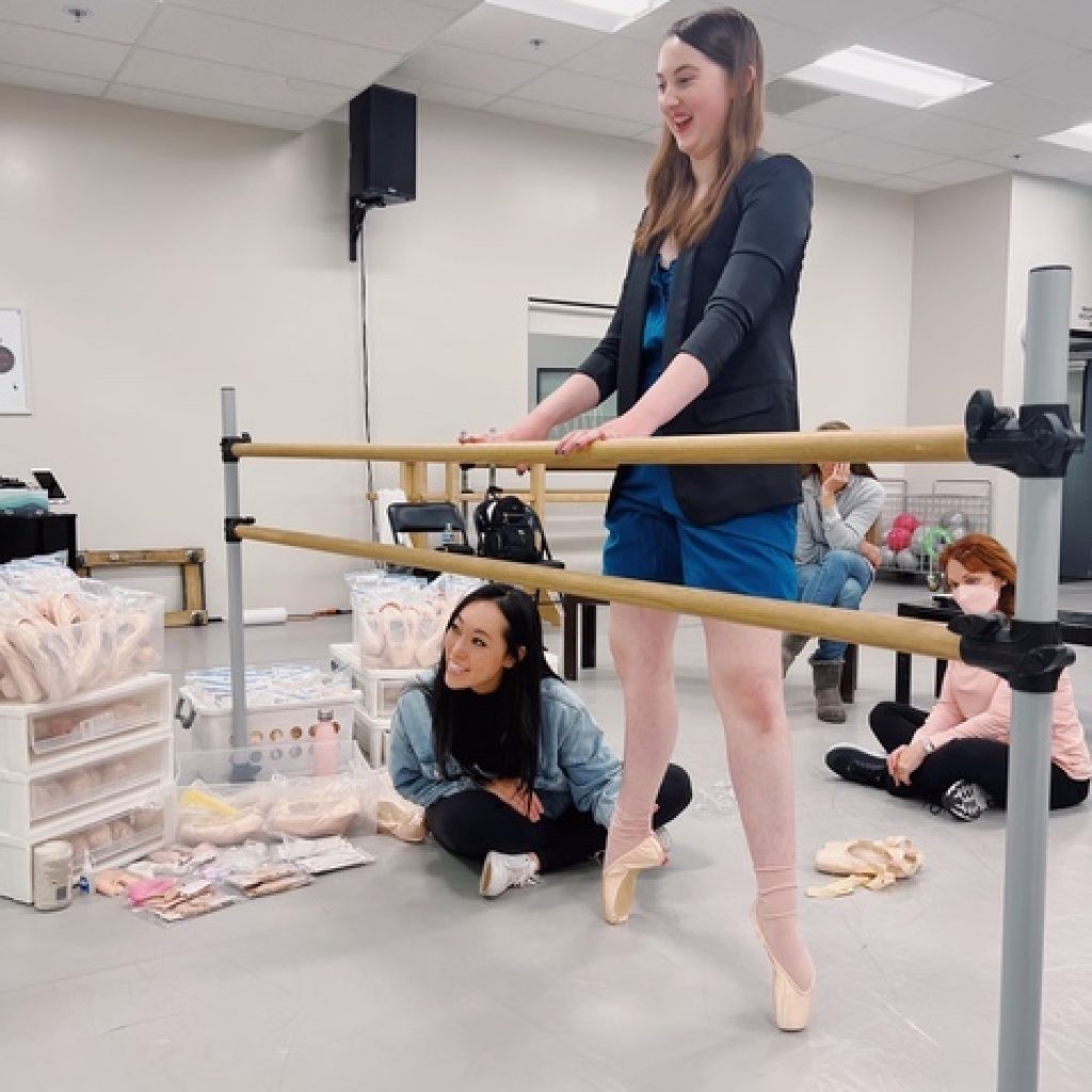 Josephine Lee fitting a dancer in pointe shoes. Photo courtesy of Lee. 