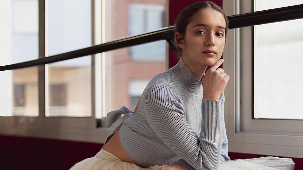 A ballerina posing by a window. Image by Freepik.