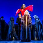 Saki Masuda (in red, center) in 'A Christmas Carol - The Musical.' Photo by Russ Rowland.