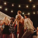 joyful outdoor night party with string lights