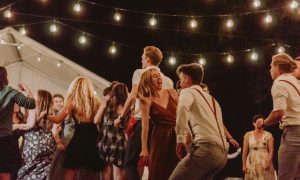 joyful outdoor night party with string lights