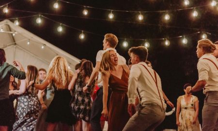 joyful outdoor night party with string lights
