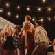 joyful outdoor night party with string lights